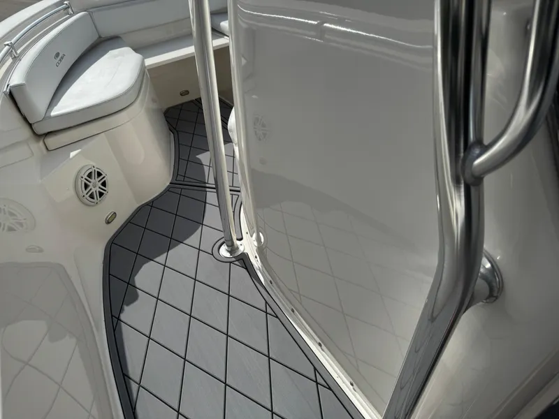 Slide: The Image of 2020 Cobia 220 Center Console boat interior with cushioned seating and non-slip flooring. - 42