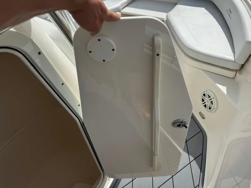 Slide: The Image of 2020 Cobia 220 Center Console boat interior with open storage compartment. - 48