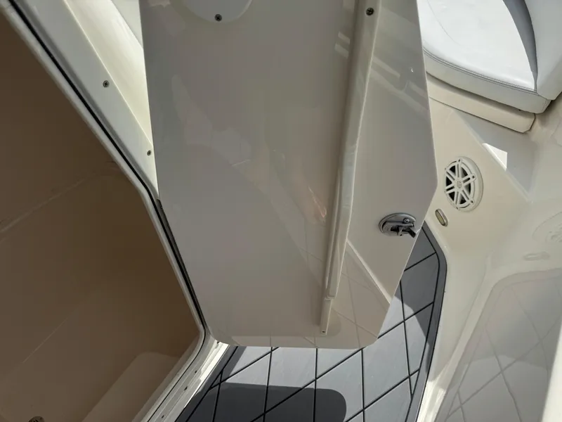 Slide: The Image of 2020 Cobia 220 Center Console boat interior, featuring open storage compartment and sleek design. - 49