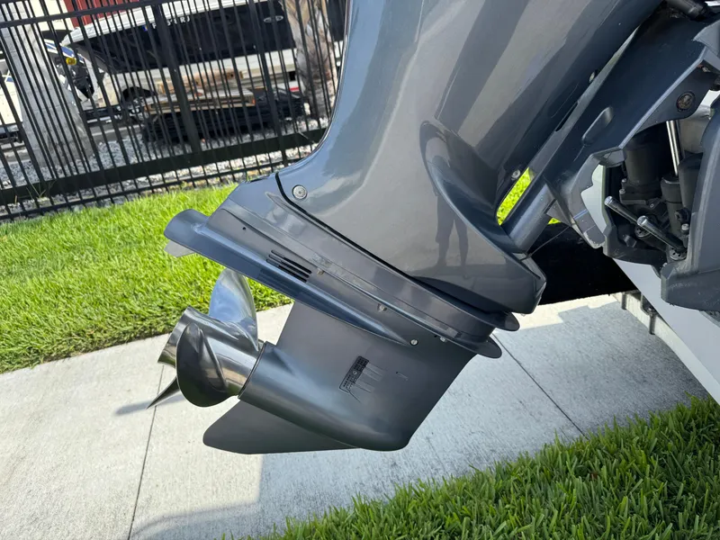 Slide: The Image of Outboard motor of a 2020 Cobia 220 Center Console boat on grass. - 6