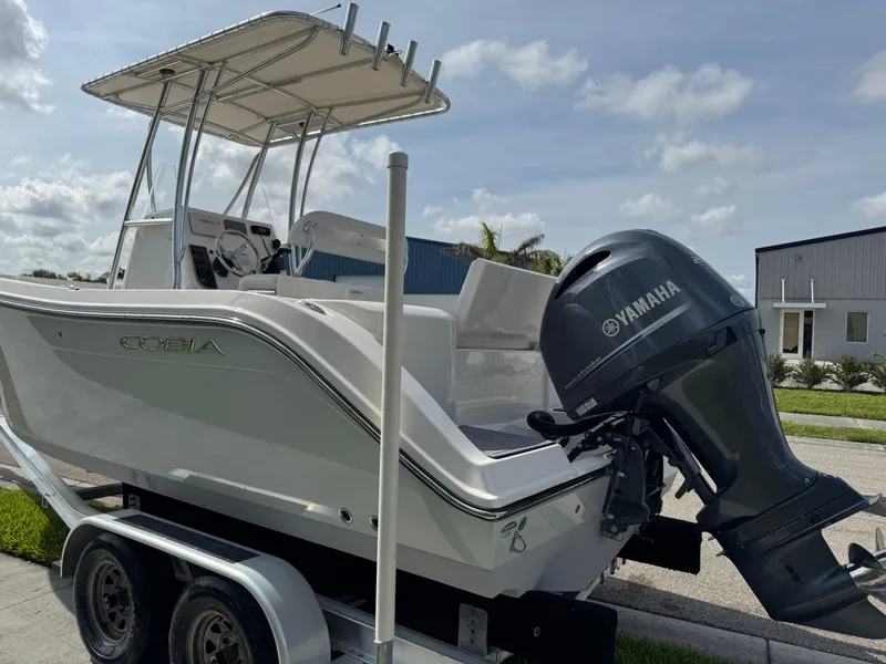 Slide: The Image of 2020 Cobia 220 Center Console boat with Yamaha engine on trailer, parked outdoors. - 7