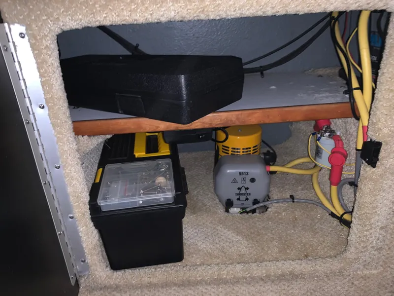 Slide: The Image of Storage compartment of a 2002 Sea Ray 340 Sundancer with tools and electrical components. - 11