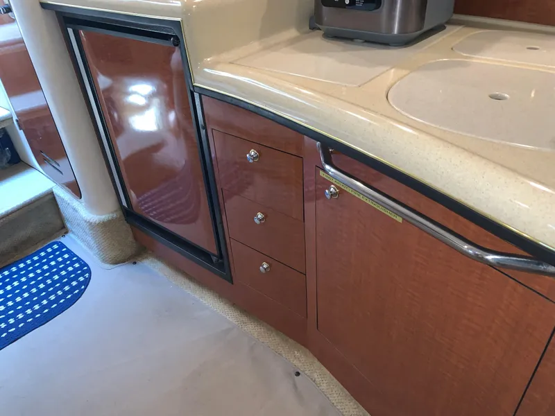 Slide: The Image of Interior of 2002 Sea Ray 340 Sundancer showing kitchen cabinetry and countertop. - 13