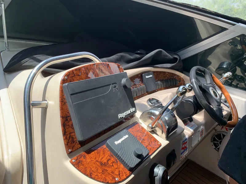 Slide: The Image of Helm of 2002 Sea Ray 340 Sundancer with Raymarine navigation system and wood accents. - 3