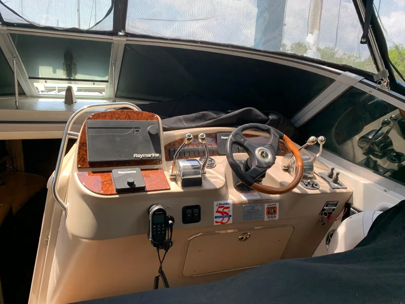 Slide: The Image of Helm of 2002 Sea Ray 340 Sundancer with Raymarine navigation system and wooden steering wheel. - 4