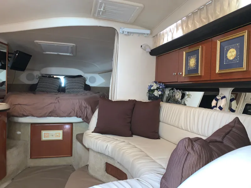 Slide: The Image of Interior of 2002 Sea Ray 340 Sundancer with cozy seating and elegant decor. - 6