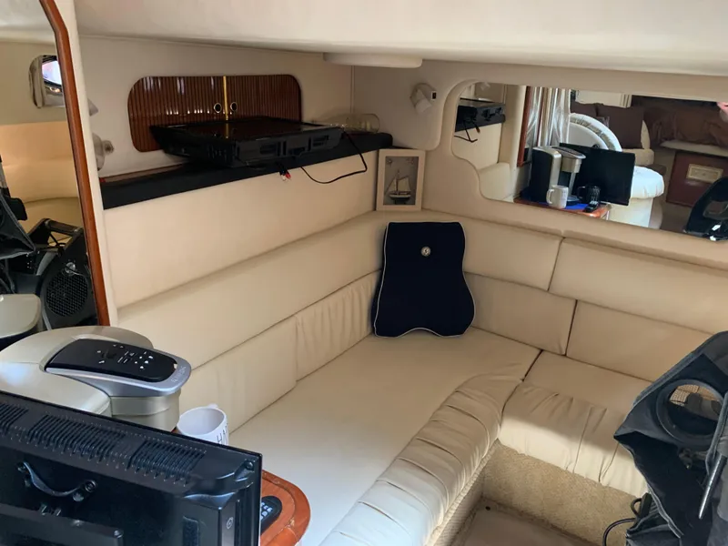 Slide: The Image of Interior of 2002 Sea Ray 340 Sundancer with cream leather seating and modern amenities. - 7