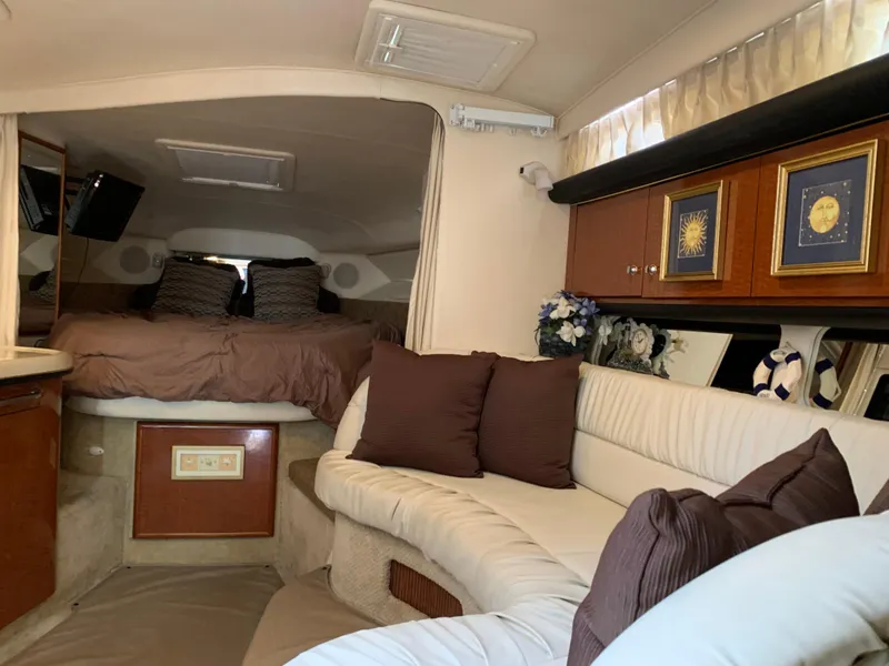 Slide: The Image of Interior of 2002 Sea Ray 340 Sundancer with cozy seating and elegant decor. - 8