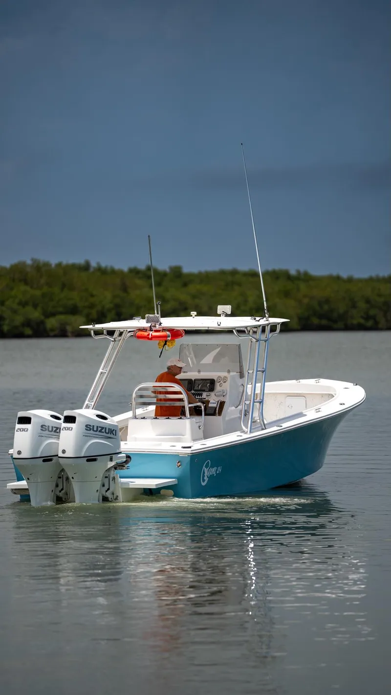 Slide: The Image of 2021 C-Hawk 29CC boat with dual Suzuki engines on calm water. - 18