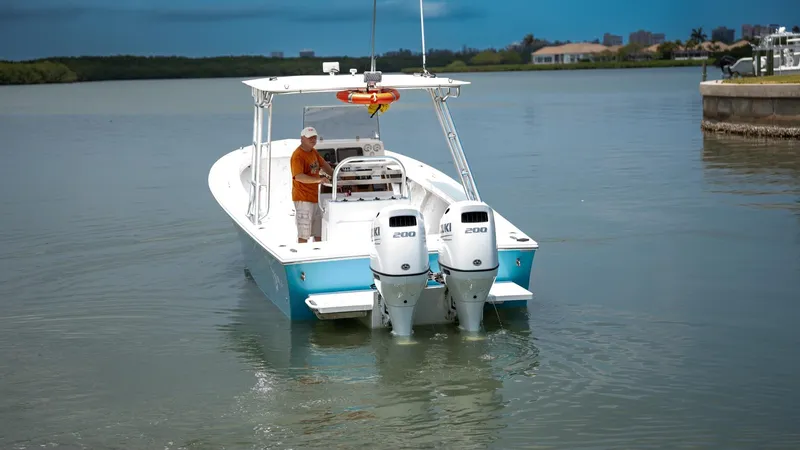 Slide: The Image of 2021 C-Hawk 29CC boat with dual engines on calm water. - 2