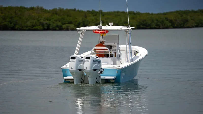 Slide: The Image of 2021 C-Hawk 29CC boat with dual Suzuki engines on calm water. - 3