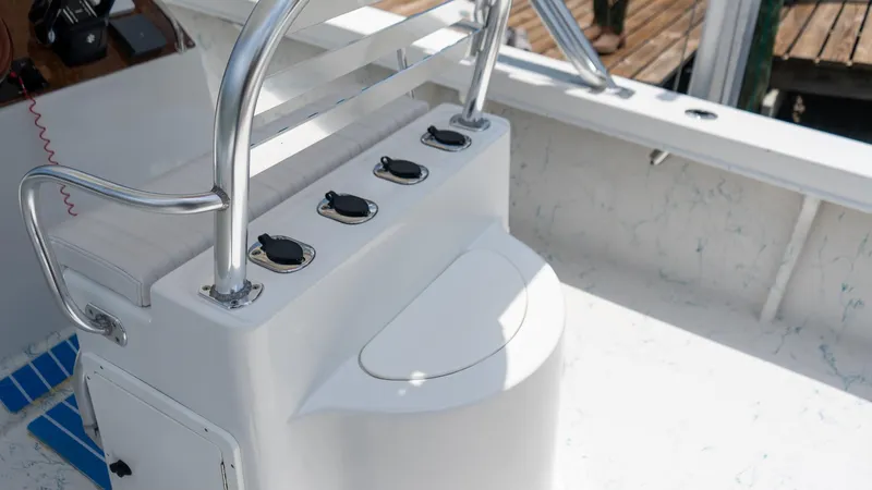 Slide: The Image of 2021 C-Hawk 29CC boat console with rod holders and storage compartment. - 8