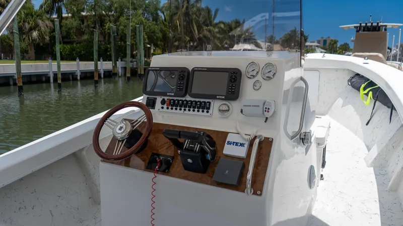 Slide: The Image of 2021 C-Hawk 29CC boat console with steering wheel and navigation equipment. - 9