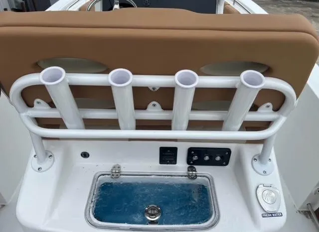 Slide: The Image of 2025 NauticStar 252 Legacy boat with rod holders and livewell. - 13
