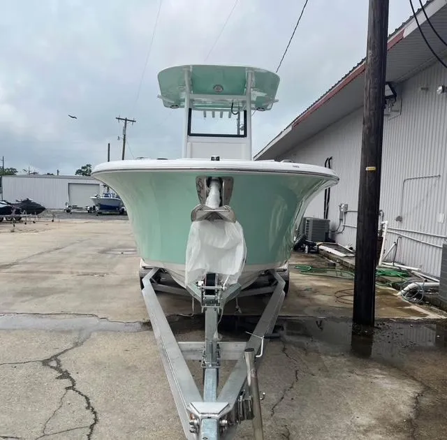 Slide: The Image of 2025 NauticStar 252 Legacy boat on trailer, parked outdoors near a building. - 4