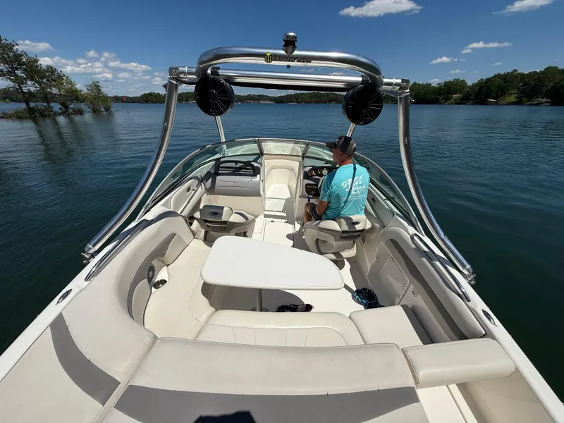 Slide: The Image of 2006 Chaparral 220 SSi boat on a lake, featuring spacious seating and sleek design. - 11