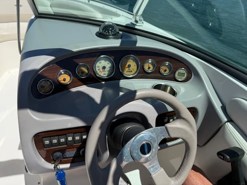 Slide: The Image of 2006 Chaparral 220 SSi boat dashboard with gauges and steering wheel. - 18