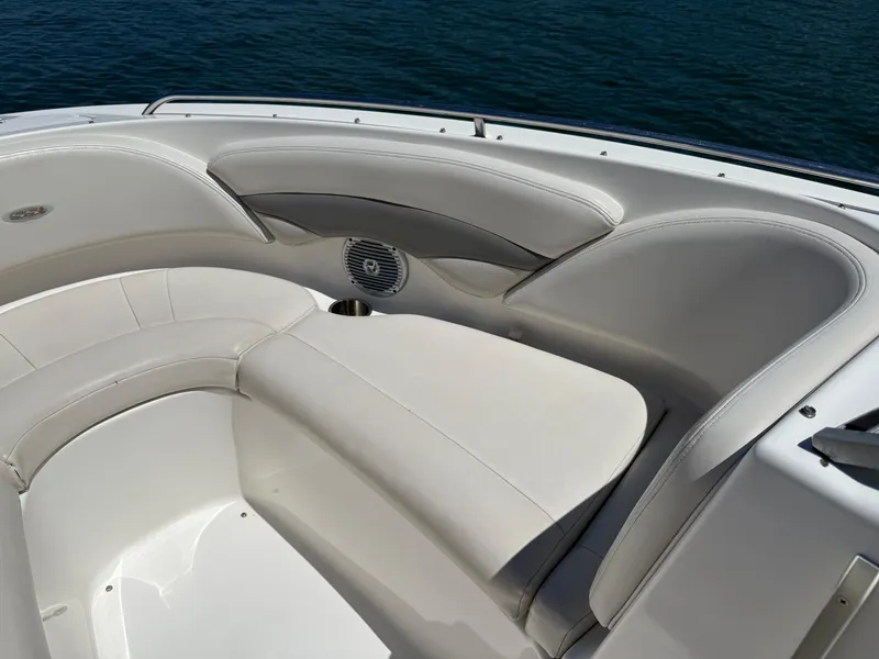 Slide: The Image of 2006 Chaparral 220 SSi boat interior with white cushioned seating and speaker. - 21