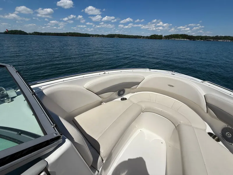 Slide: The Image of 2006 Chaparral 220 SSi boat interior with beige seating on a sunny lake. - 22