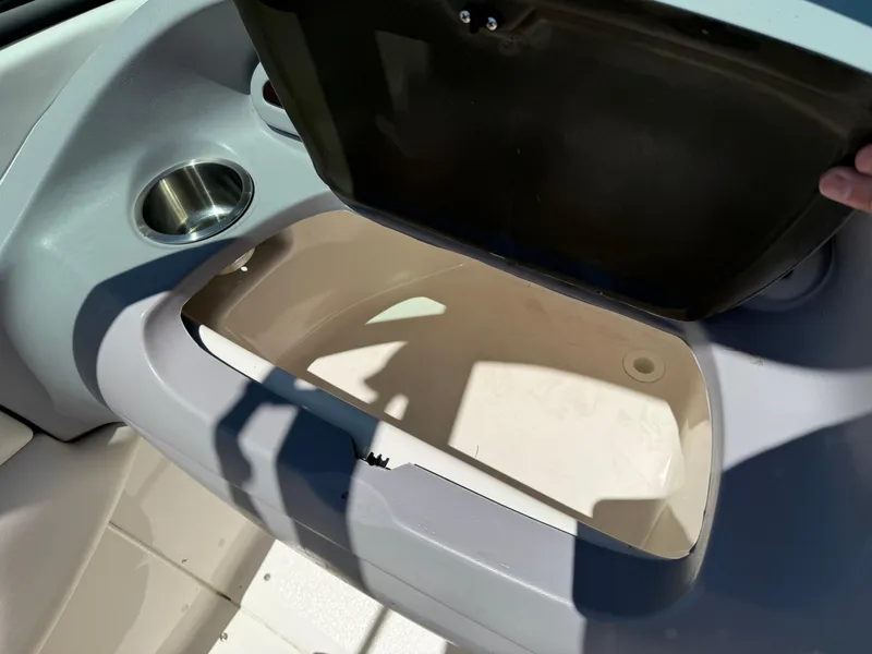Slide: The Image of Open storage compartment in 2006 Chaparral 220 SSi boat with cup holder. - 24