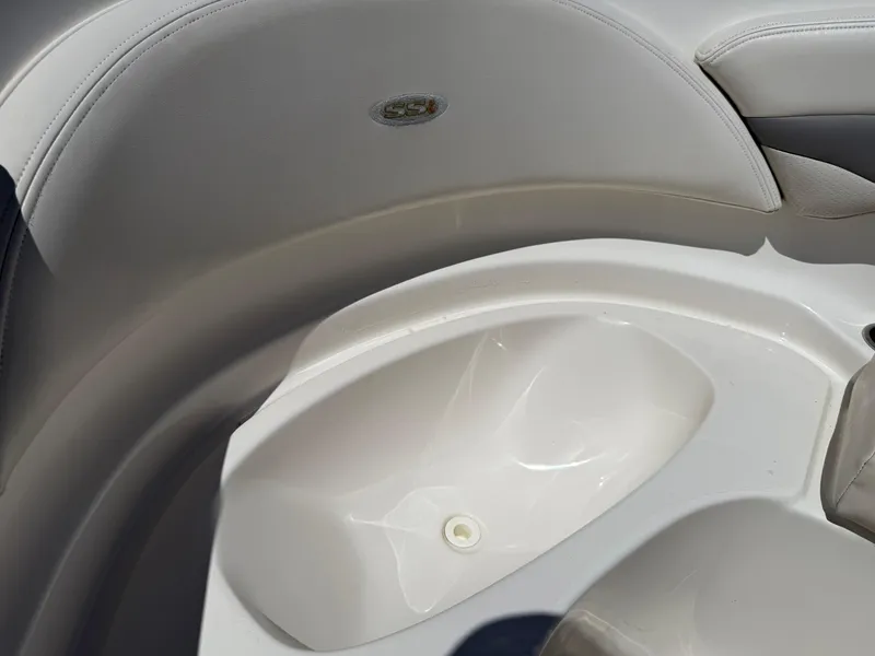 Slide: The Image of 2006 Chaparral 220 SSi boat interior detail, featuring sleek white seating and storage area. - 29
