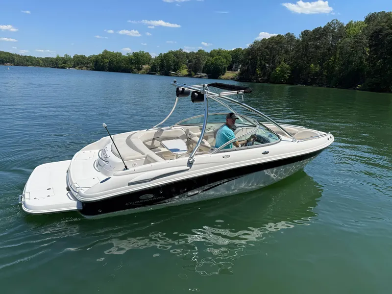 Slide: The Image of 2006 Chaparral 220 SSi boat on a serene lake with clear skies. - 4