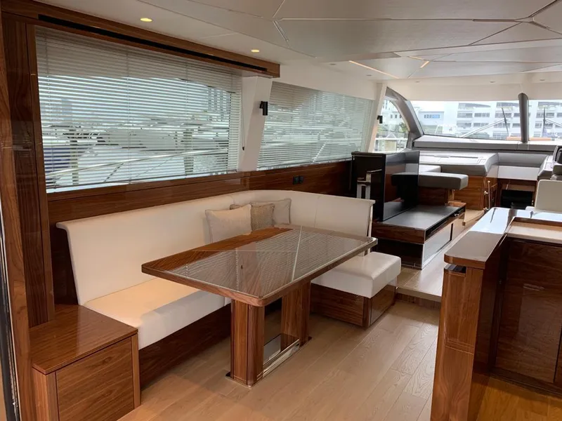 Slide: The Image of Luxurious interior of 2020 Sunseeker Manhattan 68 yacht with elegant wood and white seating. - 14