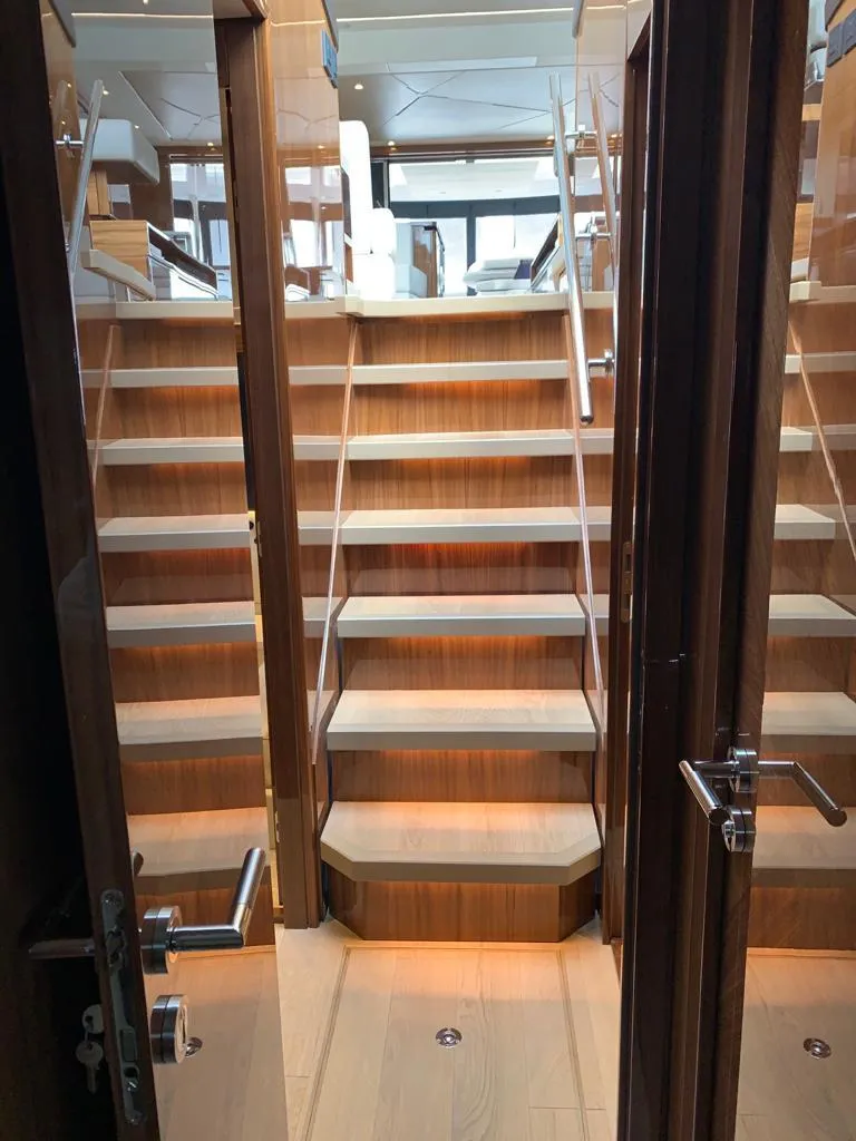 Slide: The Image of Interior view of 2020 Sunseeker Manhattan 68 yacht with elegant wooden staircase. - 17