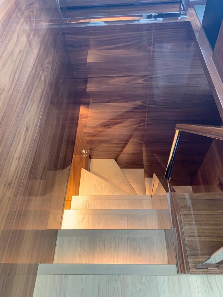 Slide: The Image of Wooden staircase with glass railing inside a 2020 Sunseeker Manhattan 68 yacht. - 23