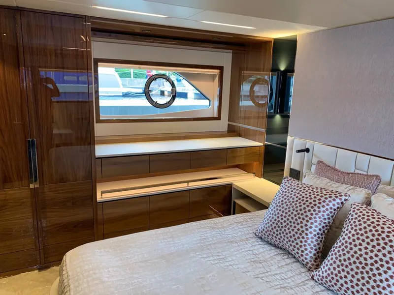 Slide: The Image of Luxurious Sunseeker Manhattan 68 yacht interior, featuring elegant wood finishes and plush bedding. - 30