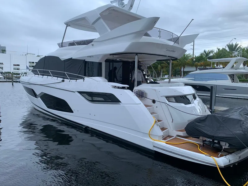 Slide: The Image of 2020 Sunseeker Manhattan 68 yacht docked at marina, showcasing sleek design and modern features. - 34