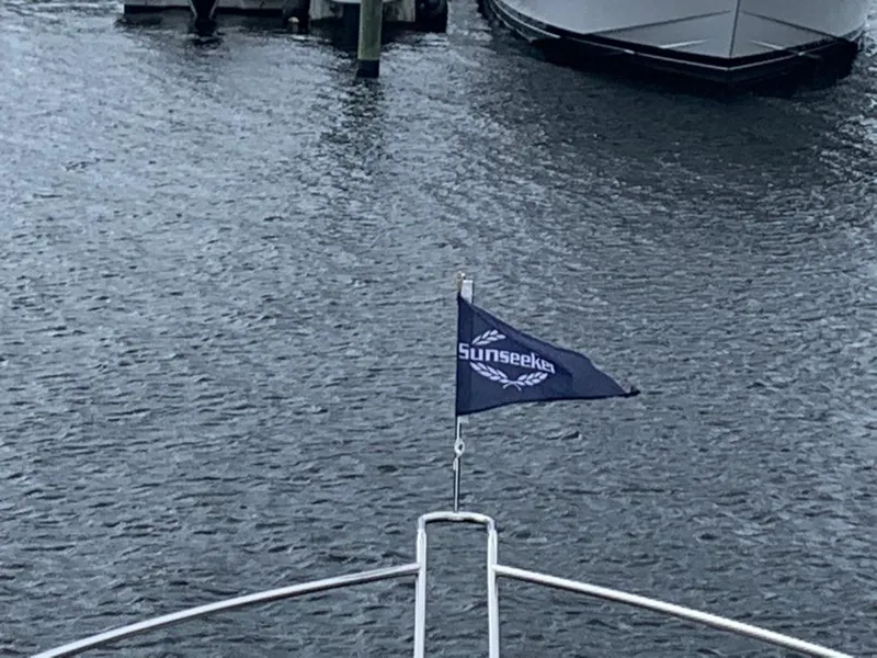 Slide: The Image of Sunseeker Manhattan 68 yacht with flag on water, 2020 model. - 36