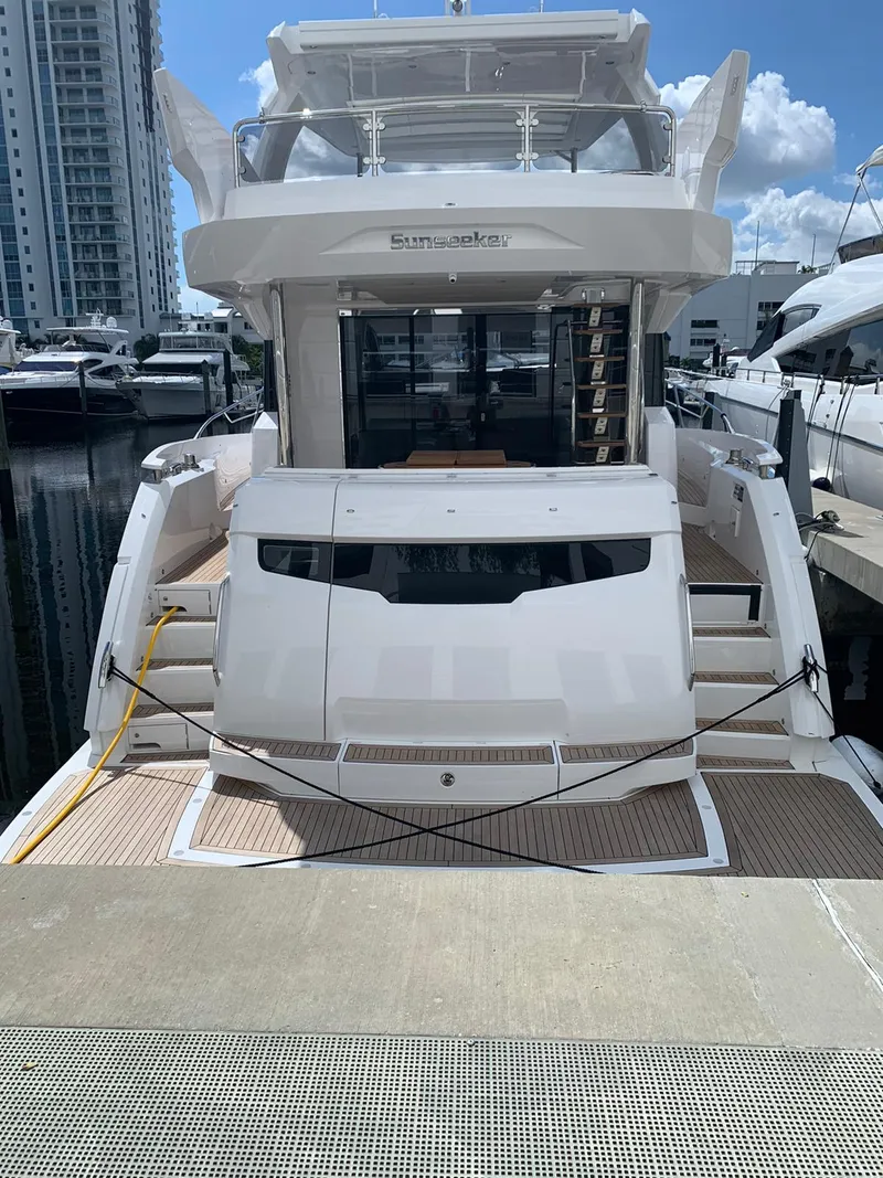 Slide: The Image of Sunseeker Manhattan 68 yacht docked at marina, rear view, 2020 model. - 4