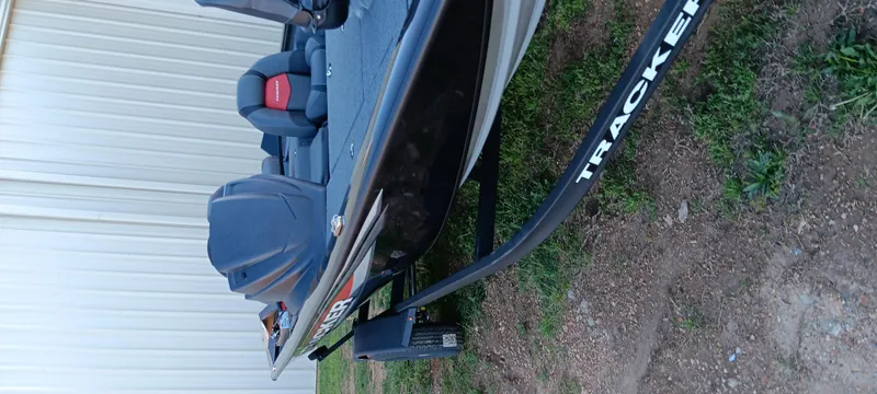 Slide: The Image of 2025 Tracker Pro Team 195 Tournament Edition boat on trailer, parked outdoors. - 10