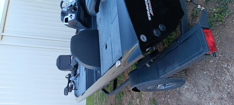 Slide: The Image of 2025 Tracker Pro Team 195 Tournament Edition boat on trailer, parked outdoors. - 11