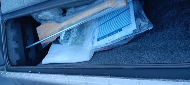 Slide: The Image of Storage compartment in 2025 Tracker Pro Team 195 Tournament Edition boat, containing various items. - 16