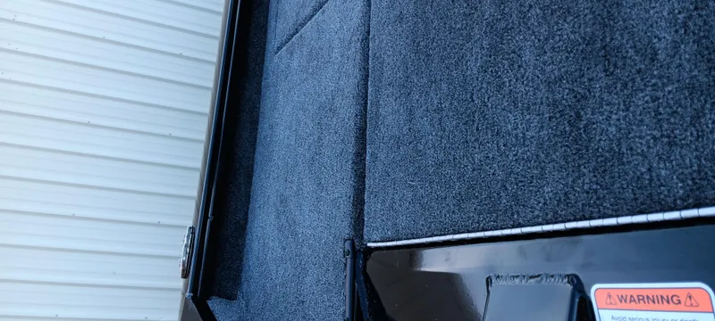 Slide: The Image of 2025 Tracker Pro Team 195 Tournament Edition boat deck with textured surface and warning label. - 7