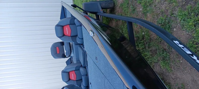 Slide: The Image of 2025 Tracker Pro Team 195 Tournament Edition boat on trailer, featuring cushioned seats. - 9