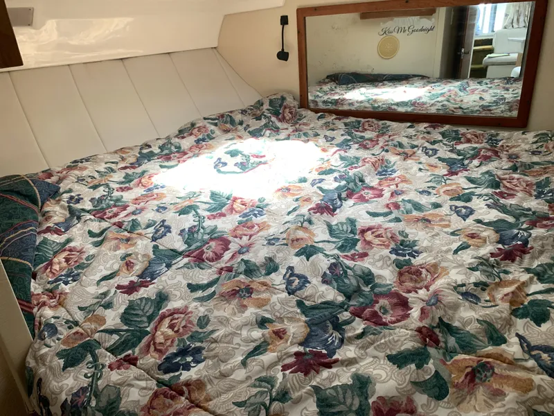 Slide: The Image of Cozy cabin bed with floral quilt in 1994 Mainship 31 Sedan Bridge. - 12