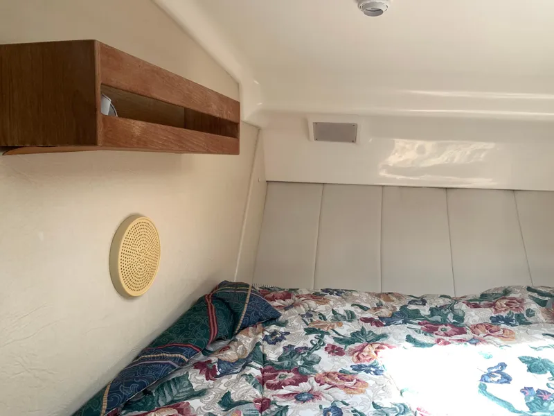 Slide: The Image of Cozy cabin interior of 1994 Mainship 31 Sedan Bridge with floral bedding. - 15