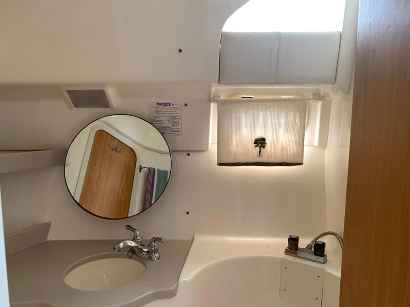 Slide: The Image of Bathroom interior of 1994 Mainship 31 Sedan Bridge with sink and mirror. - 19
