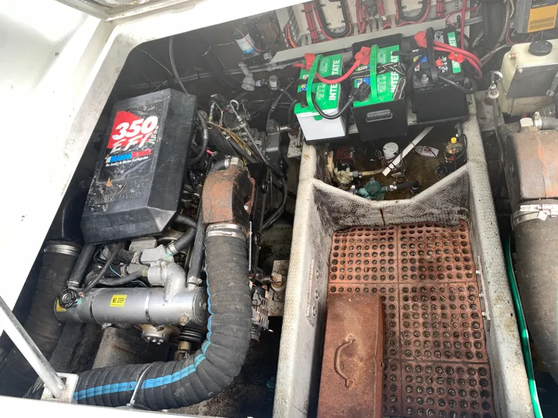 Slide: The Image of Engine compartment of a 1994 Mainship 31 Sedan Bridge with visible batteries and components. - 29