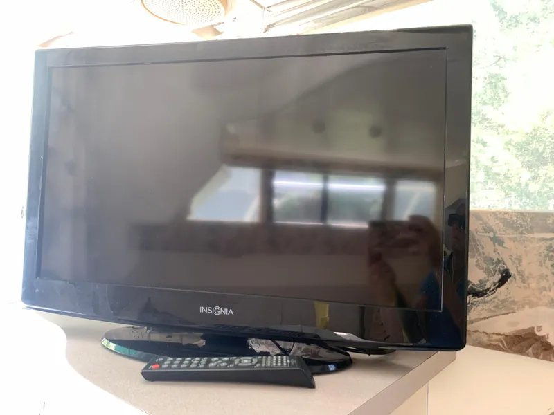 Slide: The Image of Insignia TV with remote on a Mainship 31 Sedan Bridge, 1994 model. - 3