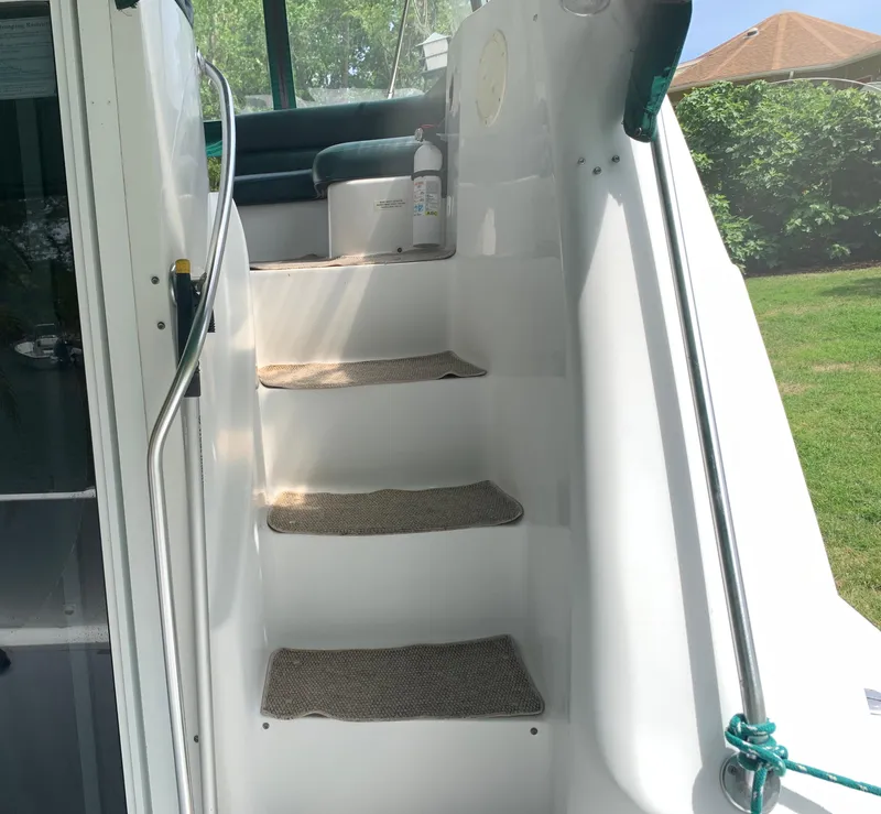 Slide: The Image of Staircase on 1994 Mainship 31 Sedan Bridge yacht with carpeted steps and handrails. - 31