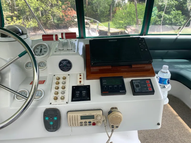 Slide: The Image of 1994 Mainship 31 Sedan Bridge helm with controls, gauges, and navigation equipment. - 34