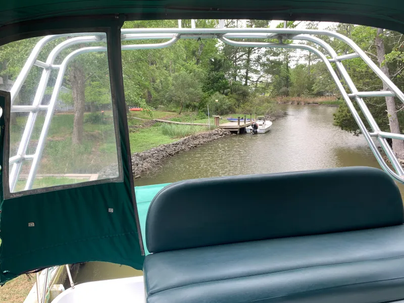 Slide: The Image of View from 1994 Mainship 31 Sedan Bridge, overlooking serene river and dock. - 46