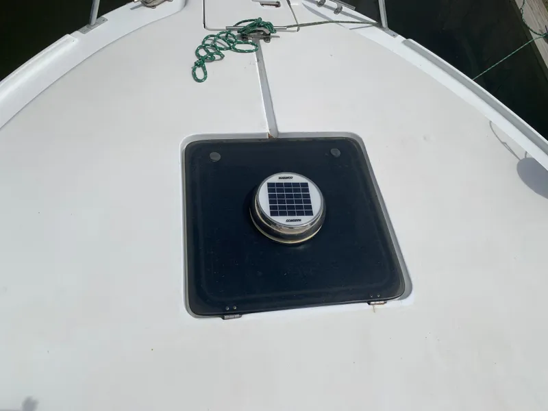 Slide: The Image of 1994 Mainship 31 Sedan Bridge deck with solar vent and rope. - 49