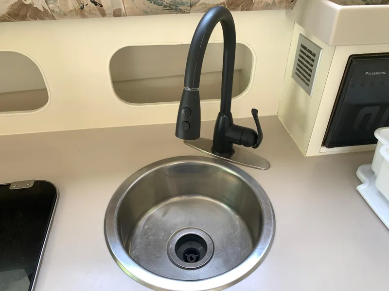 Slide: The Image of Stainless steel sink and faucet in 1994 Mainship 31 Sedan Bridge boat kitchen. - 7
