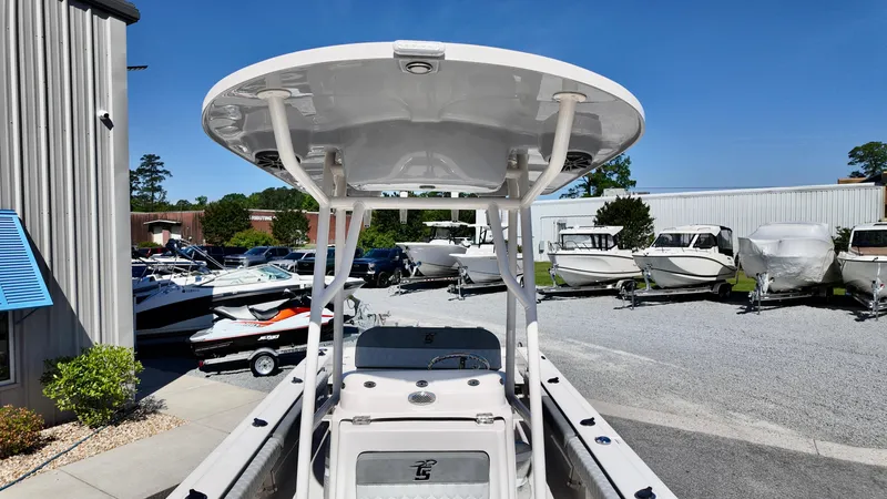 Slide: The Image of 2025 Carolina Skiff 24 Ultra Elite boat displayed at a marina with other vessels. - 10