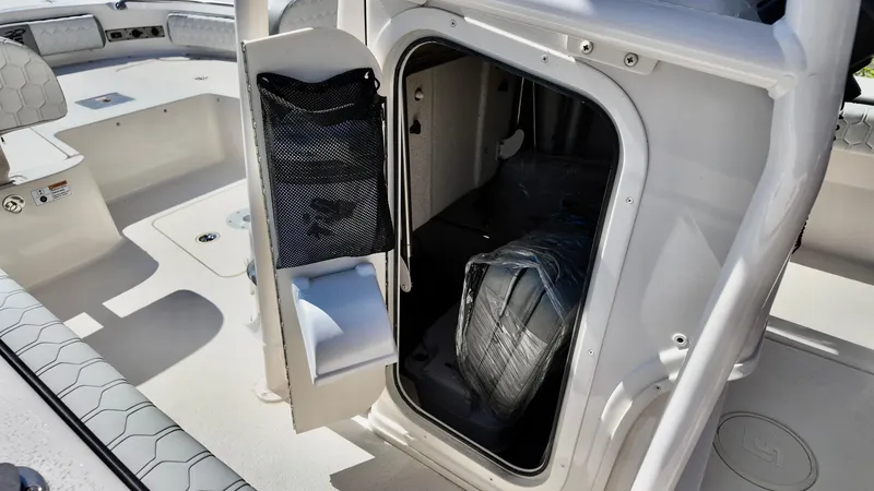 Slide: The Image of 2025 Carolina Skiff 24 Ultra Elite boat interior storage compartment. - 11